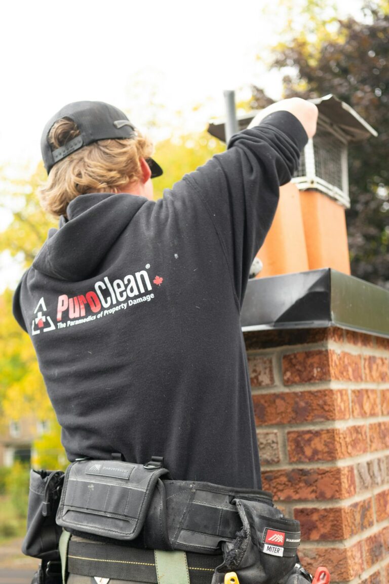 A technician from PuroClean cleans a chimney as part of property restoration services.