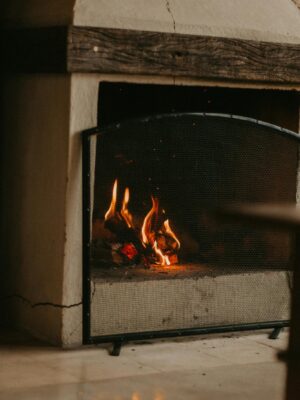 Warm and inviting fireplace with glowing logs, perfect for a cozy home atmosphere.